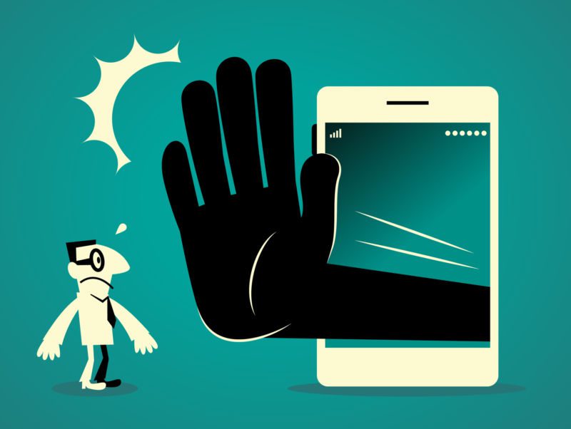 Businessman standing in front of a big smart phone (mobile phone) with a big hand making stop gesture (No!) Businessman Characters